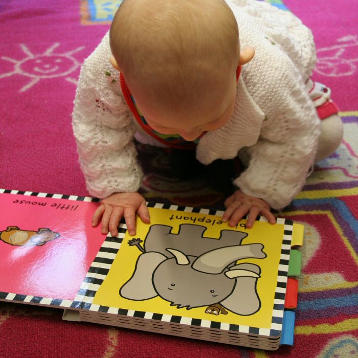 A Baby reading a book