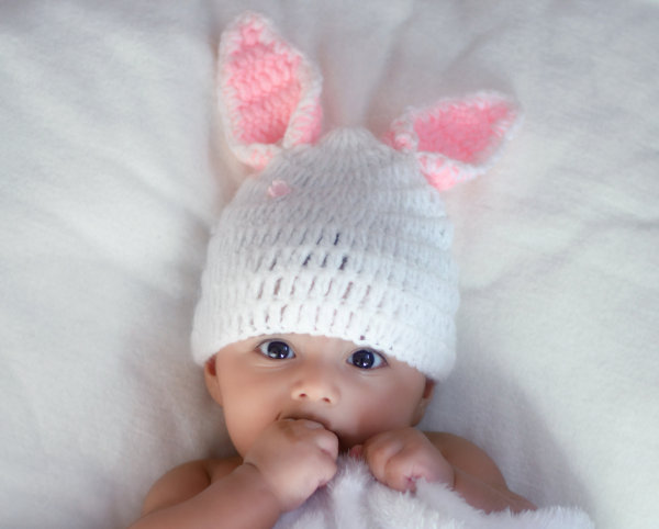 Baby with bunny ears hat on