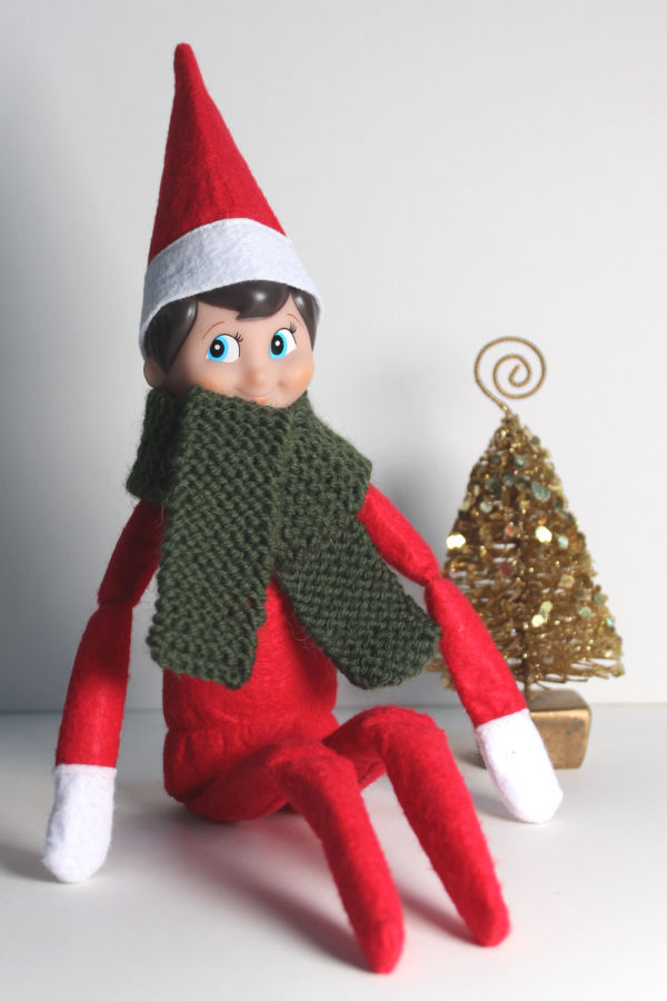 An Elf on the shelf in a snuggly handknit scarf.