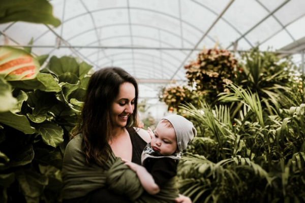 A mother and child surrounded by plants.