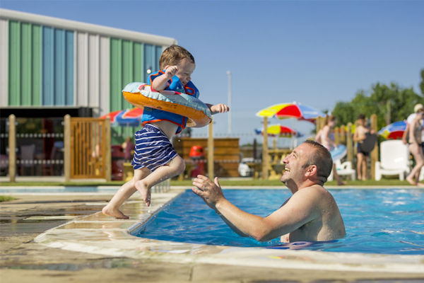 child and parent in a swimming pool